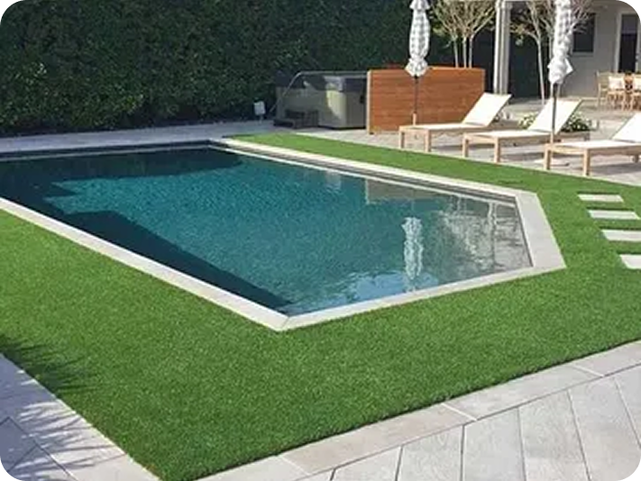 Swimming pool surrounded by green lawn