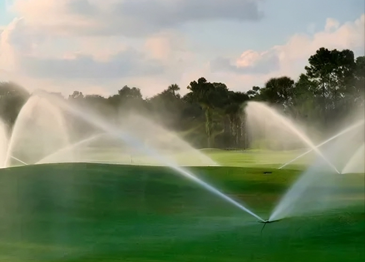 Sprinklers on a lush golf course